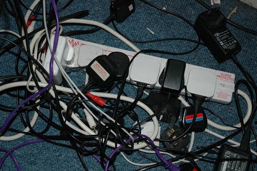 A tangle of cables and plugs behind a desk — look familiar?